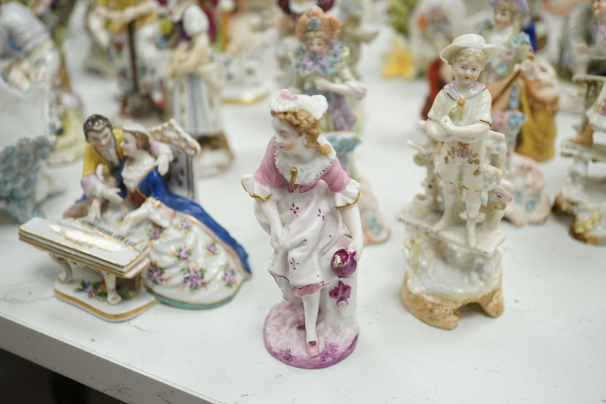 A large collection of small to medium German, French and English porcelain figurines and groups, tallest 18cm